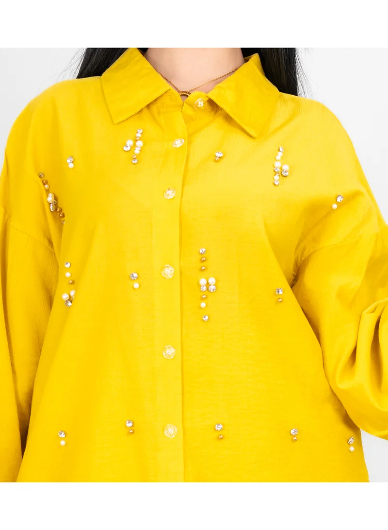 اكسا طقم عصري من قطعتين: بلوزة وبنطال بتفاصيل كريستالية